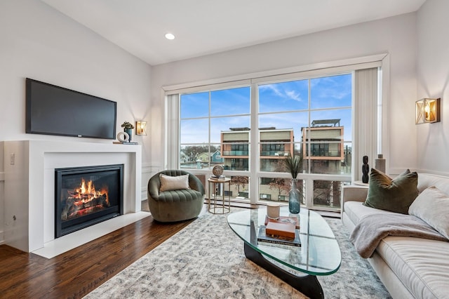 living room with a fireplace with flush hearth, wood finished floors, and recessed lighting