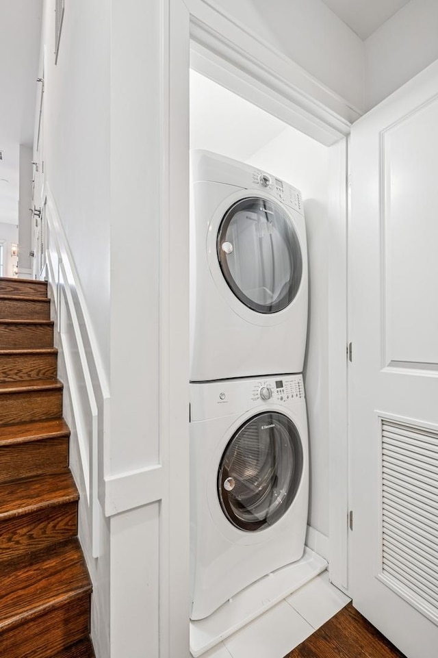 washroom featuring stacked washer and dryer and laundry area