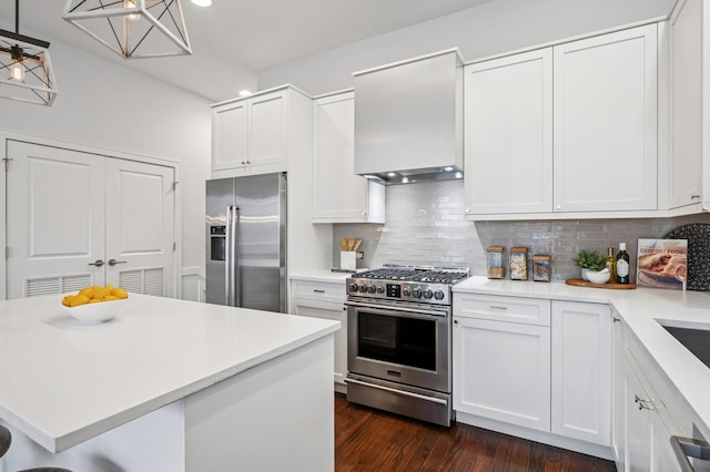 kitchen featuring appliances with stainless steel finishes, light countertops, premium range hood, and decorative backsplash