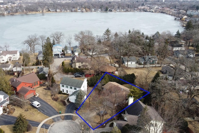 birds eye view of property with a water view