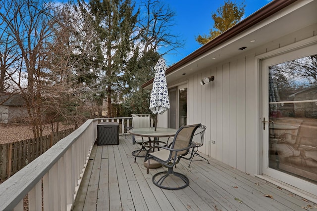 deck with outdoor dining area and fence