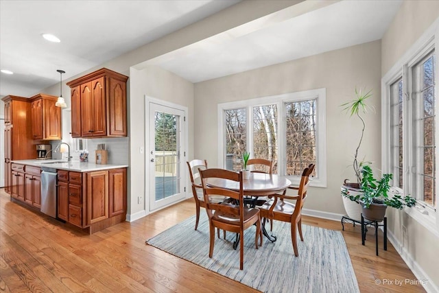 dining area with light wood-style floors, baseboards, and recessed lighting