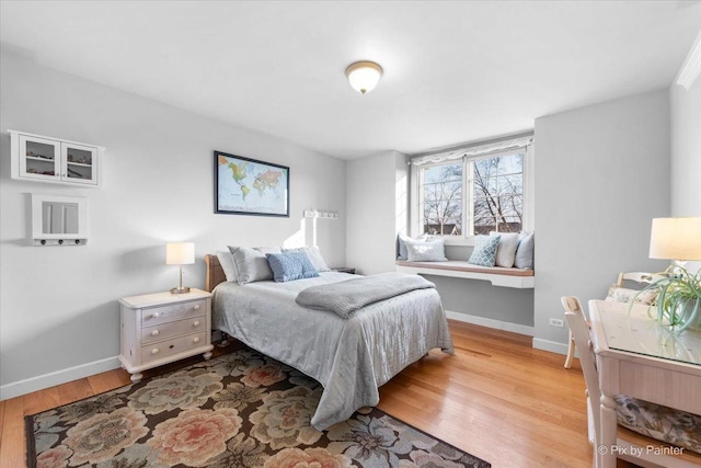 bedroom featuring baseboards and wood finished floors