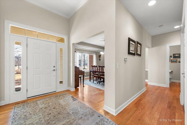 entrance foyer featuring recessed lighting, visible vents, baseboards, ornamental molding, and light wood-type flooring