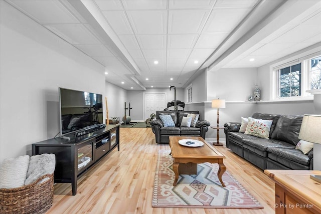 living room with light wood-type flooring, baseboards, and recessed lighting