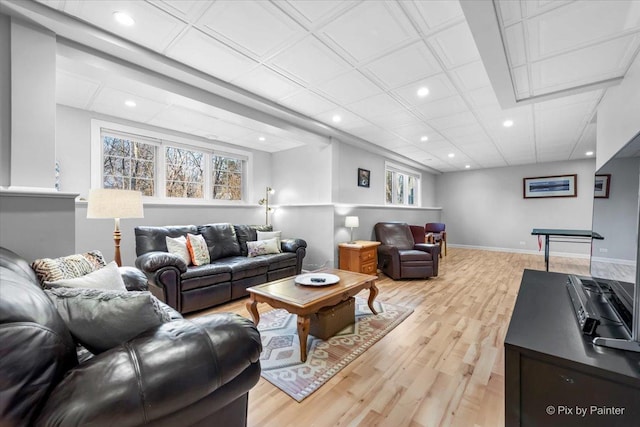 living room with light wood finished floors, baseboards, and recessed lighting