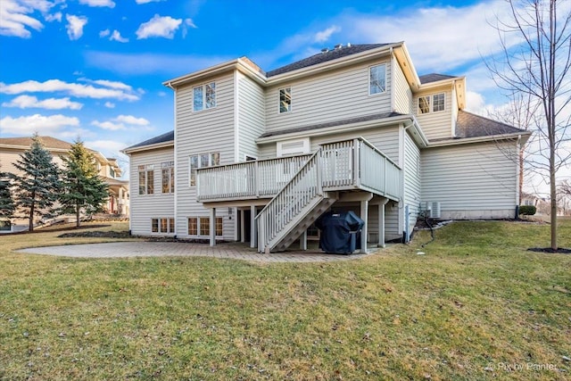 back of property featuring stairs, a lawn, a patio area, and a wooden deck