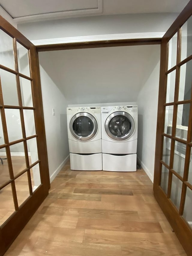 laundry room with light wood-style floors, laundry area, independent washer and dryer, and baseboards