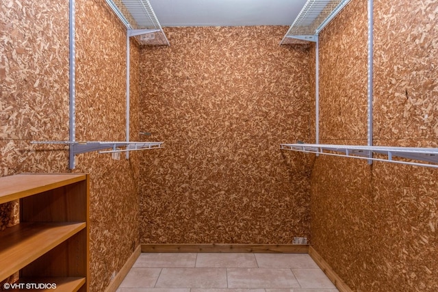 walk in closet with tile patterned floors