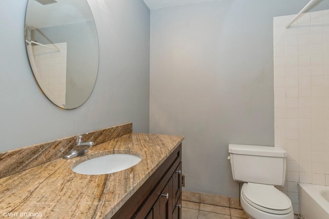 bathroom featuring shower / washtub combination, vanity, toilet, and tile patterned floors