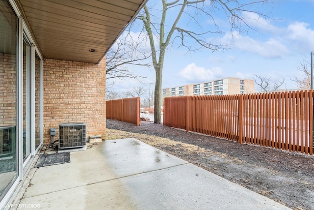 view of patio featuring central AC unit and a fenced backyard