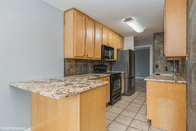 kitchen featuring light tile patterned floors, tasteful backsplash, a sink, a peninsula, and black appliances