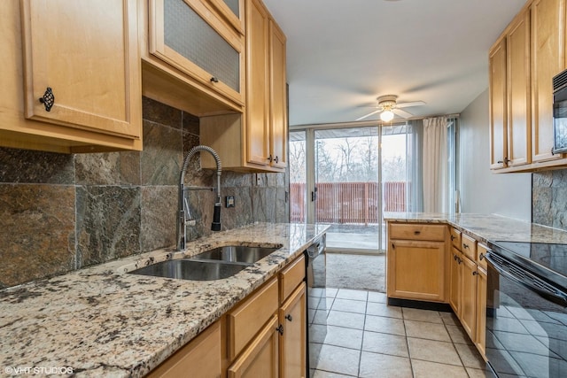 kitchen featuring black appliances, tasteful backsplash, a ceiling fan, and a sink