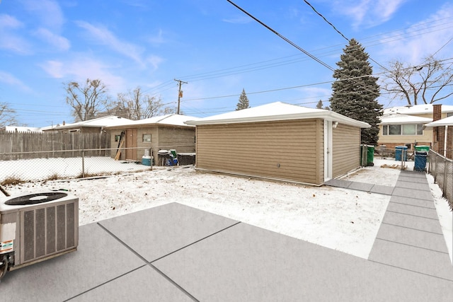 garage with fence and central air condition unit