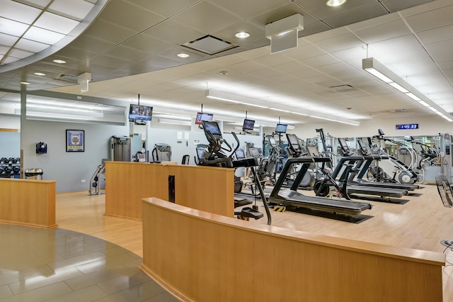 exercise room featuring wood finished floors and visible vents