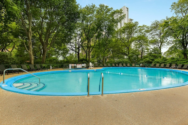 community pool featuring a patio area and fence