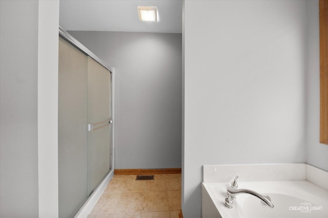 2355 Avalon Ct, Aurora, IL 60503 - bathroom featuring a shower stall, a bath, and tile patterned floors