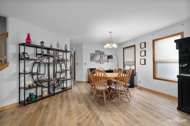 2355 Avalon Ct, Aurora, IL 60503 - dining room with light wood-style flooring, a chandelier, and baseboards