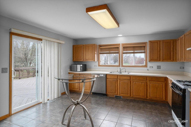 2355 Avalon Ct, Aurora, IL 60503 - kitchen featuring stainless steel dishwasher, range with gas stovetop, a sink, and plenty of natural light