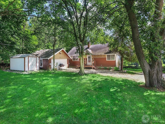 39575 N Dilleys Rd, Wadsworth, IL 60083 - view of front of property with a front yard, a shingled roof, a storage shed, a chimney, and an outbuilding