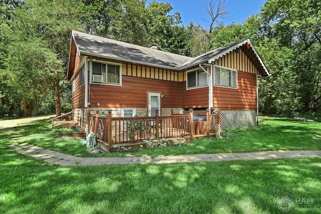 39575 N Dilleys Rd, Wadsworth, IL 60083 - rear view of property featuring stone siding, a lawn, board and batten siding, cooling unit, and a wooden deck