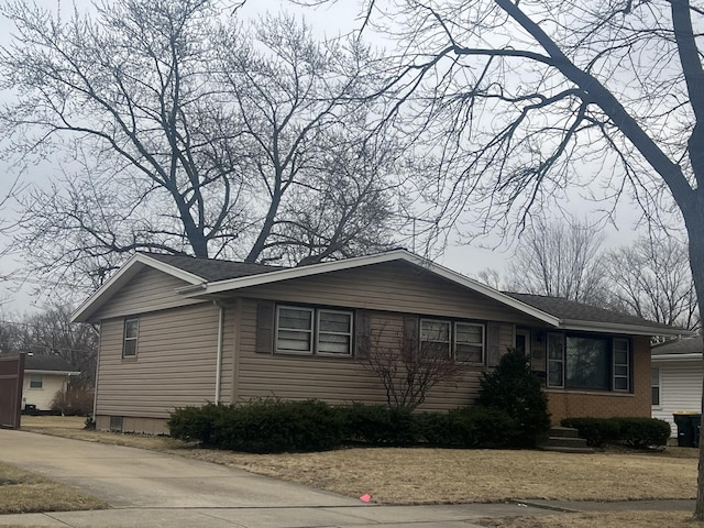 view of side of property featuring brick siding