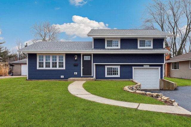 tri-level home with a front lawn, a garage, driveway, and roof with shingles