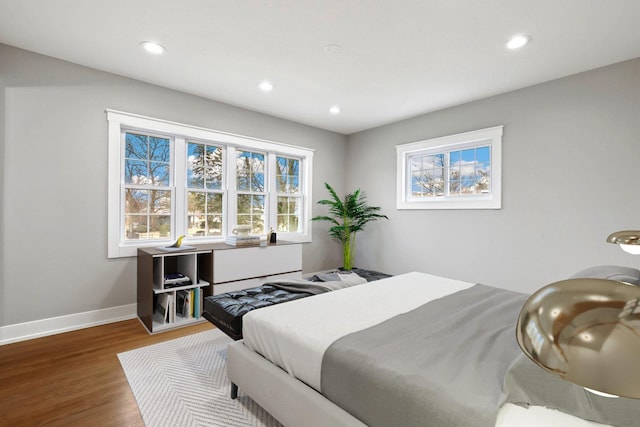 bedroom featuring recessed lighting, wood finished floors, and baseboards