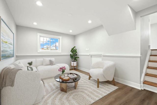 living area with stairway, recessed lighting, wood finished floors, and baseboards