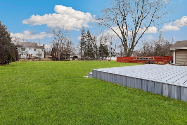 view of yard with a wooden deck and fence