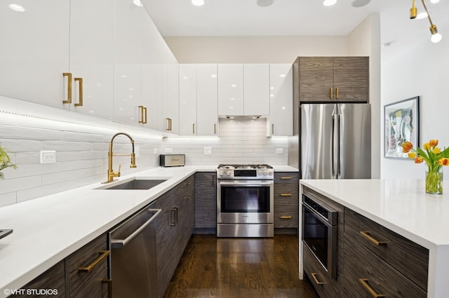 kitchen featuring a sink, modern cabinets, appliances with stainless steel finishes, and white cabinets