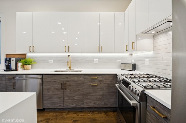 kitchen with white cabinetry, modern cabinets, appliances with stainless steel finishes, and a sink