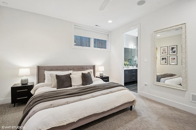 bedroom featuring connected bathroom, carpet floors, baseboards, and a ceiling fan