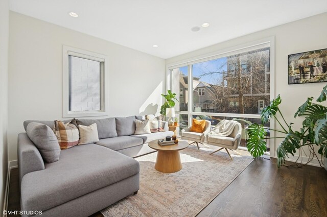 living area with recessed lighting and wood finished floors