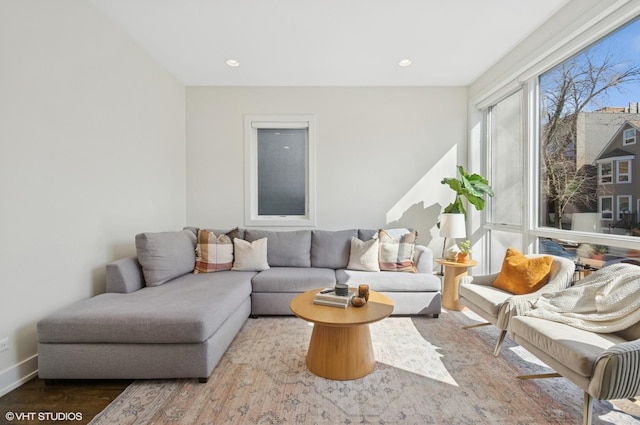 living room with recessed lighting, baseboards, and wood finished floors