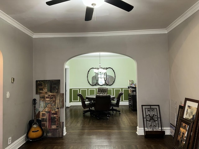 dining space with ornamental molding, arched walkways, ceiling fan with notable chandelier, and wood finished floors