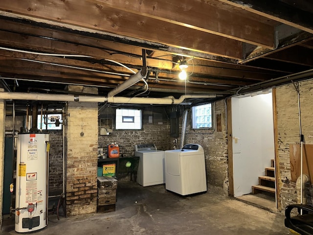 basement with water heater, stairway, and washer and dryer