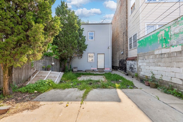 rear view of property with fence