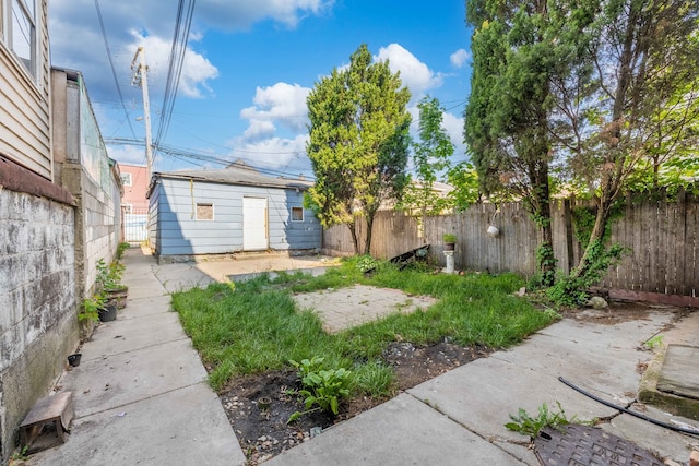 view of yard with an outbuilding and a fenced backyard