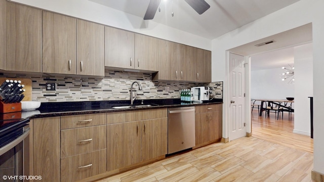 kitchen featuring tasteful backsplash, visible vents, appliances with stainless steel finishes, a sink, and dark stone countertops