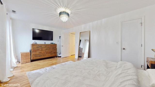 bedroom featuring visible vents and wood finished floors