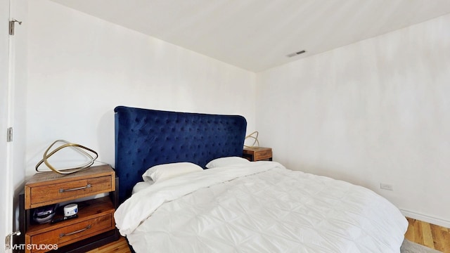 bedroom featuring wood finished floors