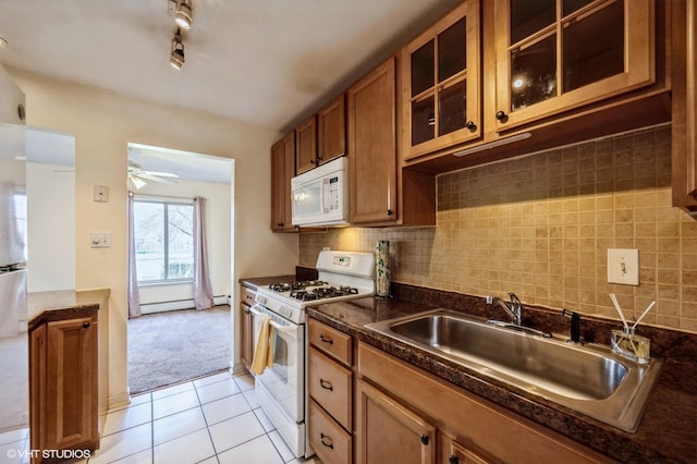1501 E Churchill Dr Unit 104, Palatine, IL 60074 - kitchen with white appliances, brown cabinetry, a ceiling fan, dark countertops, and a sink