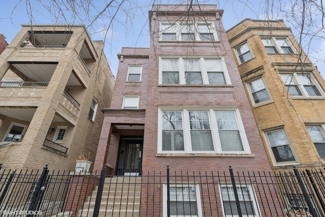 view of building exterior featuring a fenced front yard