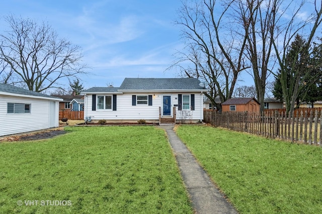 view of front of home with fence and a front lawn