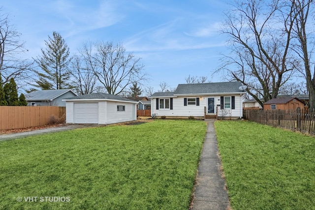 view of front of property with driveway, a front yard, fence, and an outdoor structure