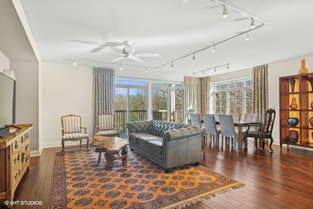 living room featuring rail lighting, wood finished floors, a wealth of natural light, and a ceiling fan