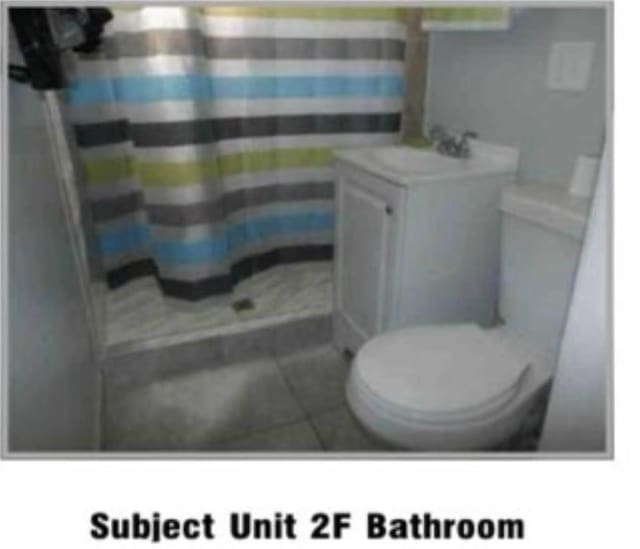 full bathroom with toilet, a shower with curtain, tile patterned flooring, and vanity