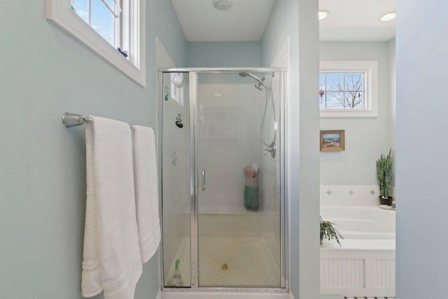 bathroom with a garden tub and a shower stall