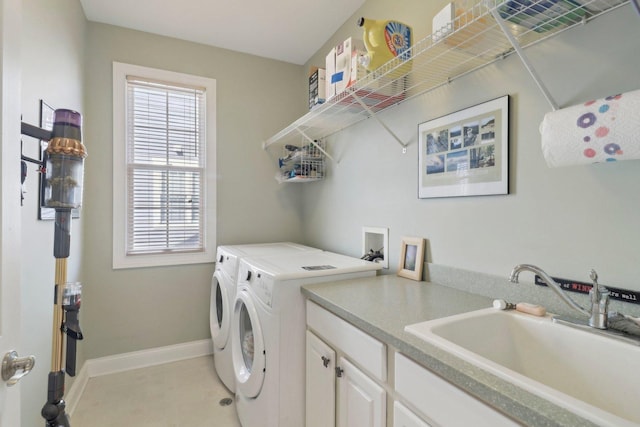 laundry area with a sink, baseboards, independent washer and dryer, and light tile patterned floors